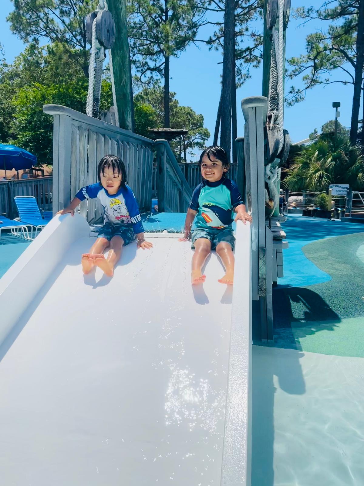 Kids playing on a water slide